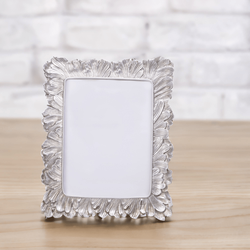 A Vintage Silver Photo Frame on a wooden table.