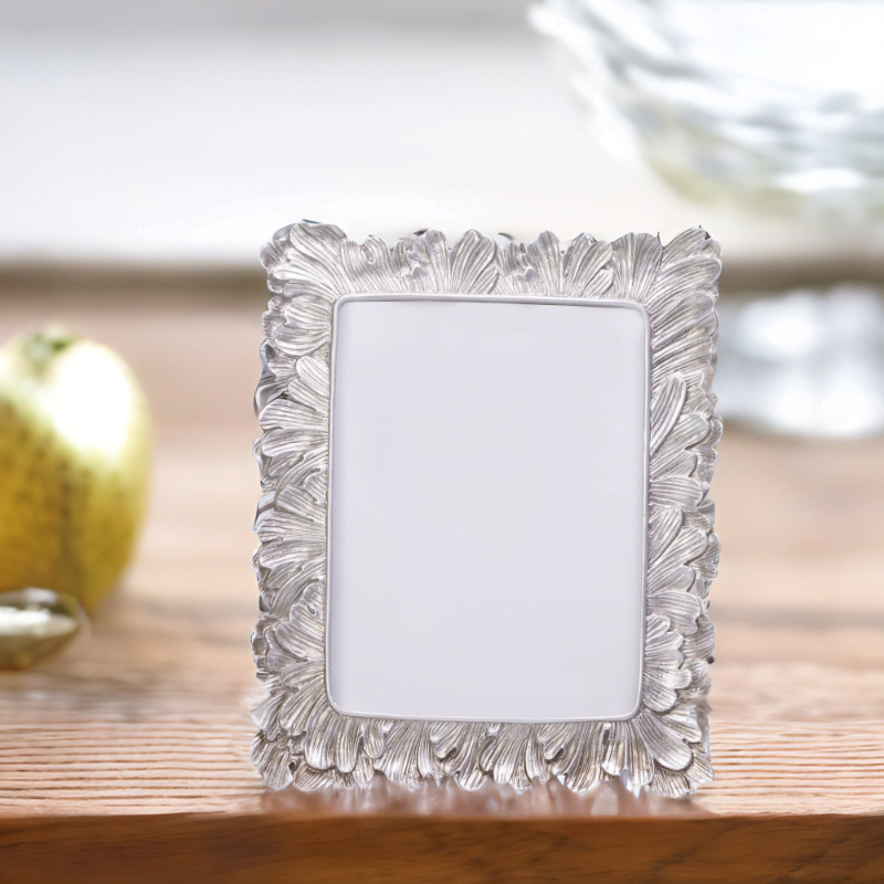 A Vintage Silver Photo Frame on a wooden table.