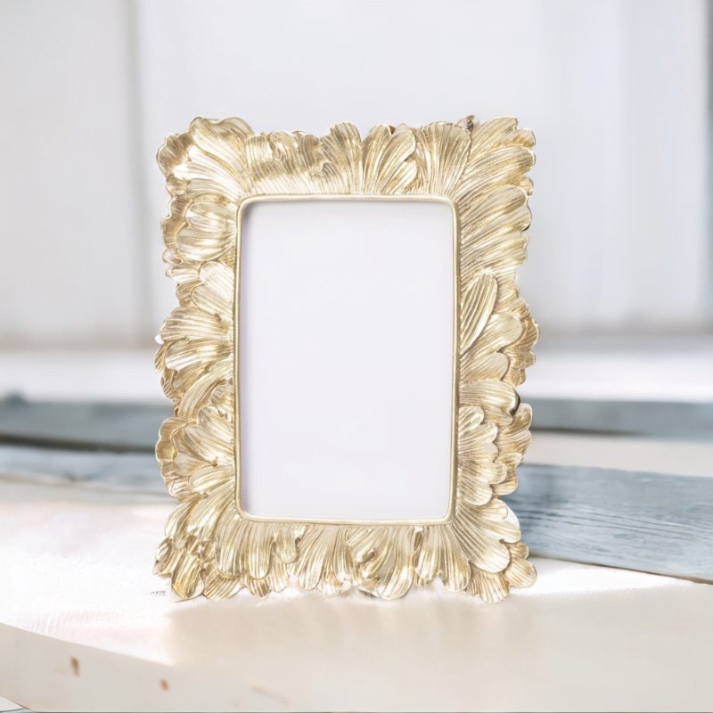 A Vintage Gold Photo Frame sitting on a table.