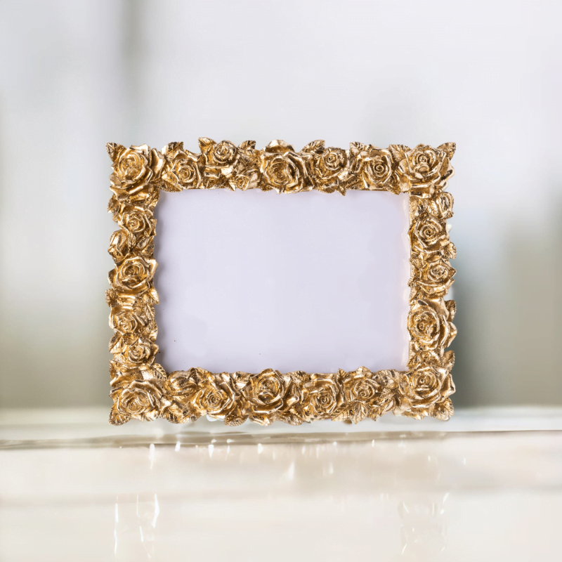 A gold rose landscape photo frame on wooden table.