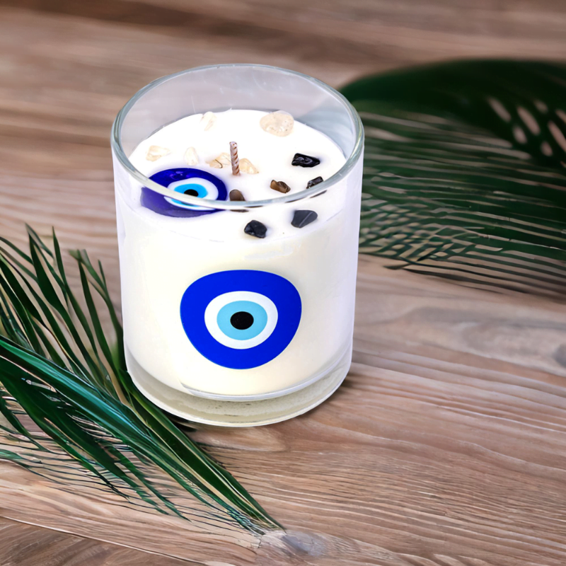 An Evil Eye Lavender Amber Candle sits on a wooden table.
