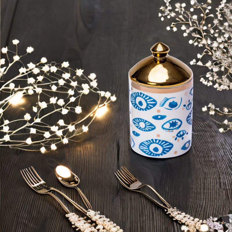 An Evil Eye Canister with a fork and spoon.