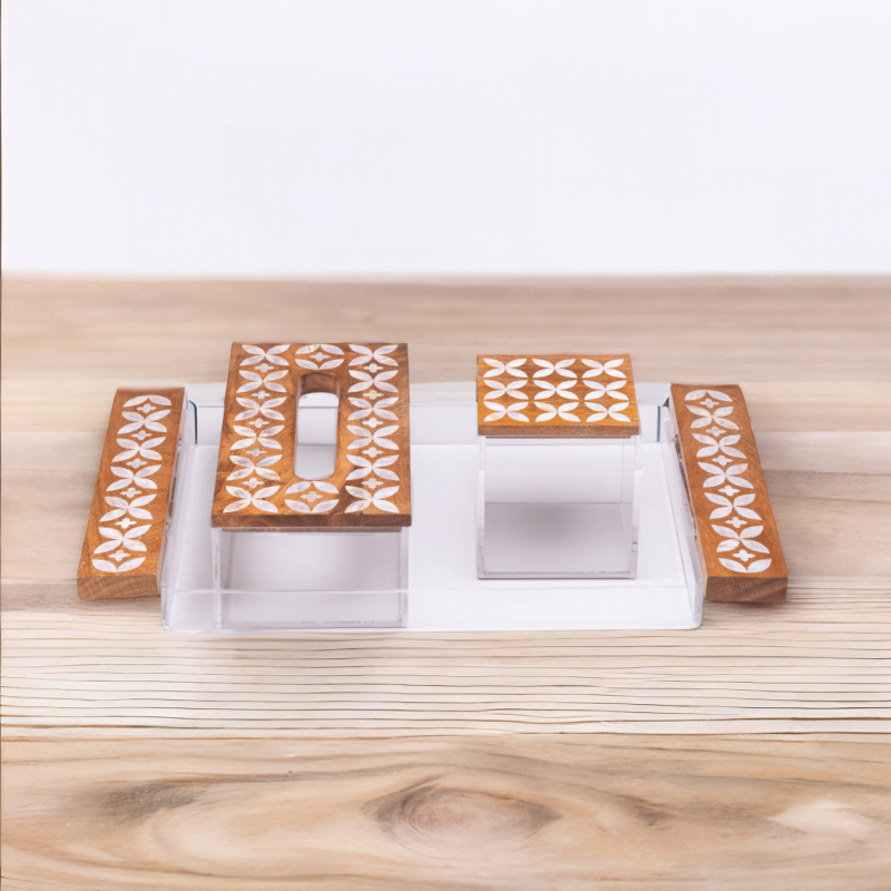 Premium Acrylic and Wood tray adorned with quality mother of pearl inlay, set consists of tray, tissue box and storage box styled with artistic flower pattern sitting on a wooden table.