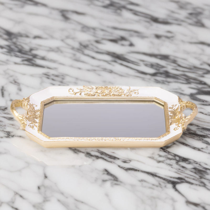 An Octagon mirror tray on a marble countertop.