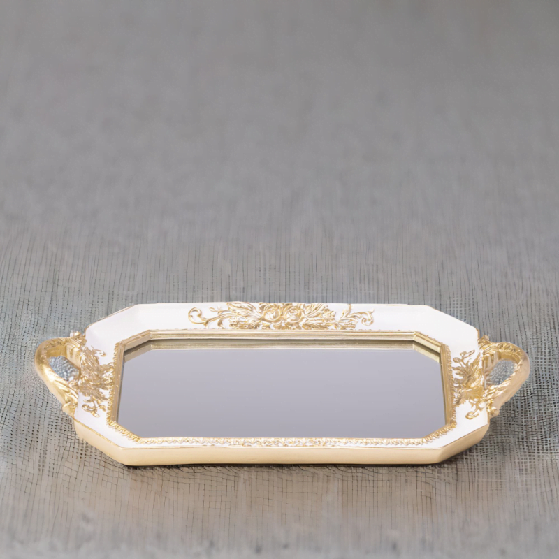 A white octagon tray with a mirror bottom and gold accents.
