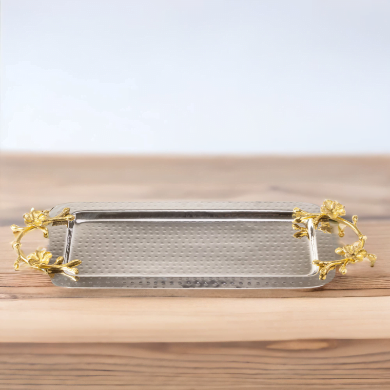 A Long Floral Tray with gold leaf handles on a wooden table.