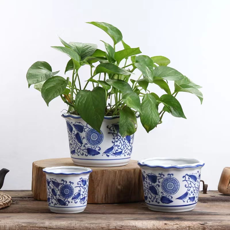 a set of 3 diffrent size white and blue planters witha wavey edges , can put artificial plants or flowers or a small size real plants.